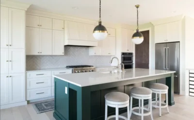 Modern kitchen with green island and stools